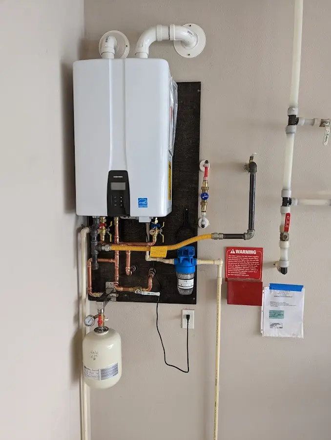 Professional plumber installing copper piping in a Blanchester home